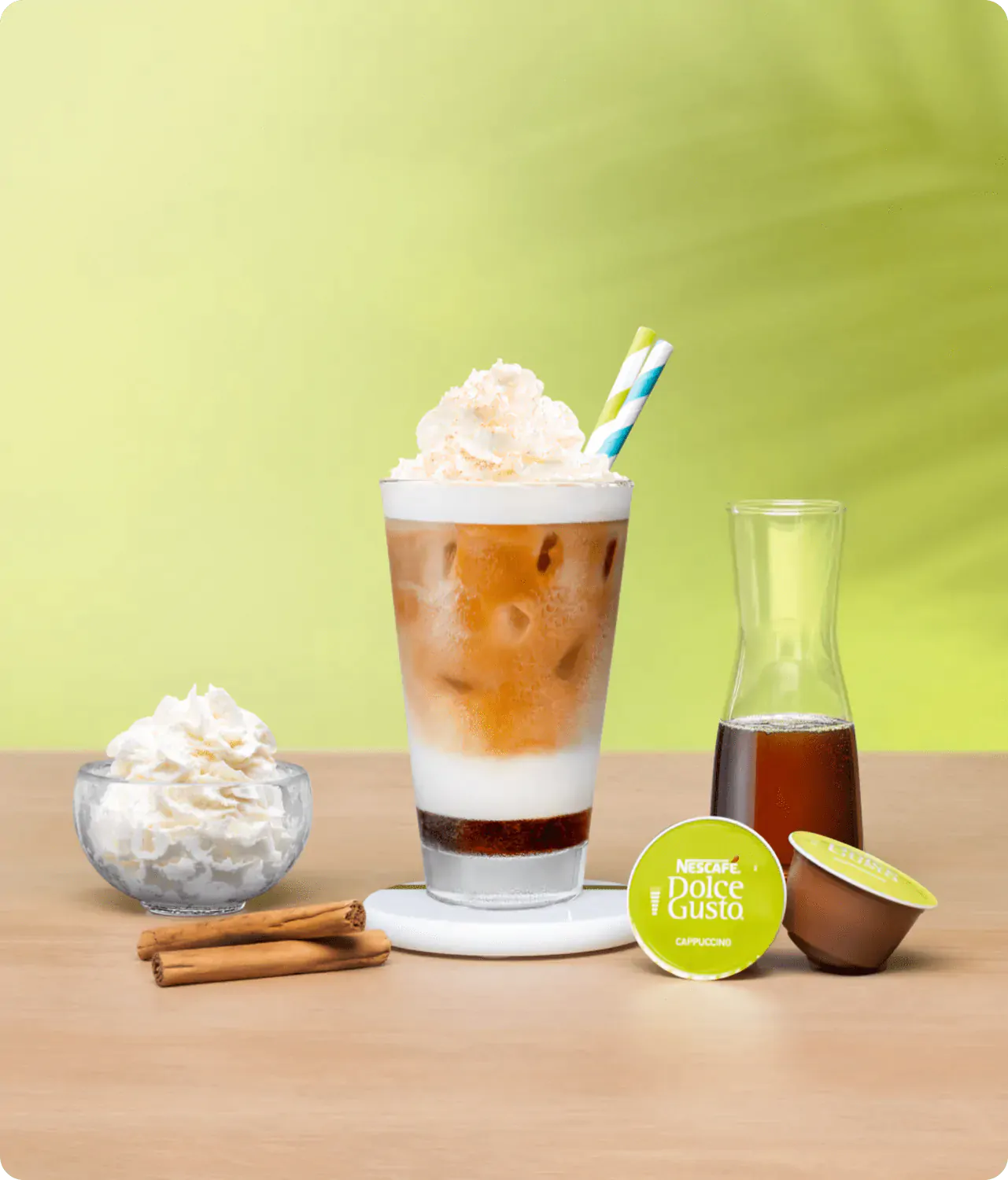 iced cappuccino next to a coffee capsule