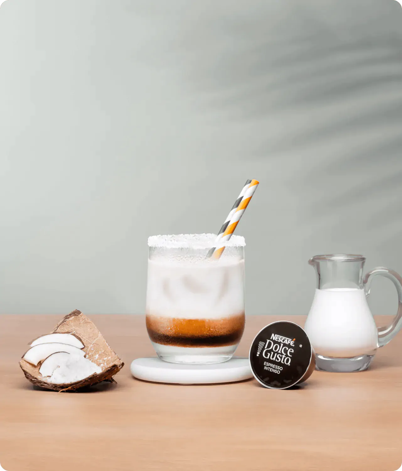 iced espresso next to a coffee capsule